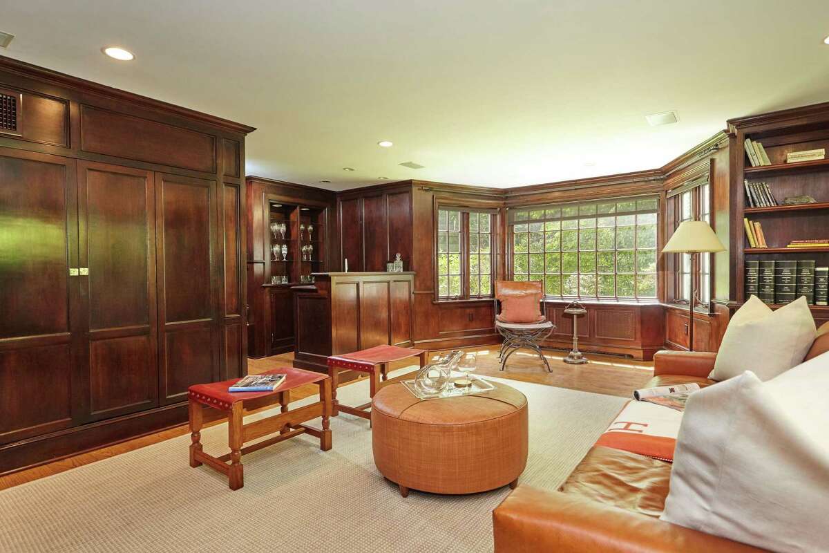 The large paneled library features a stone fireplace, built-in bookshelves, numerous multi-paned windows, and a service bar. In the gourmet eat-in kitchen there are marble counters, a center island, built-in desk or home command area, and a breakfast or casual dining area. The large paneled library features a stone fireplace, built-in bookshelves, numerous multi-paned windows from which to enjoy views of the attractive grounds, and a service bar; another amenity for entertaining family and friends. There are six bedrooms in this house, in addition to the two in the guest house. The master suite and three other bedrooms are on the second floor and two more are found on the third floor. In the generously sized master the features include a sitting area, French doors to a private balcony/deck, and a spa-sized bath which opens to a dressing room and walk-in closet. On the third floor there is also a playroom or reading nook. In addition to the media and billiard rooms, the lower level also enjoys a fitness room.