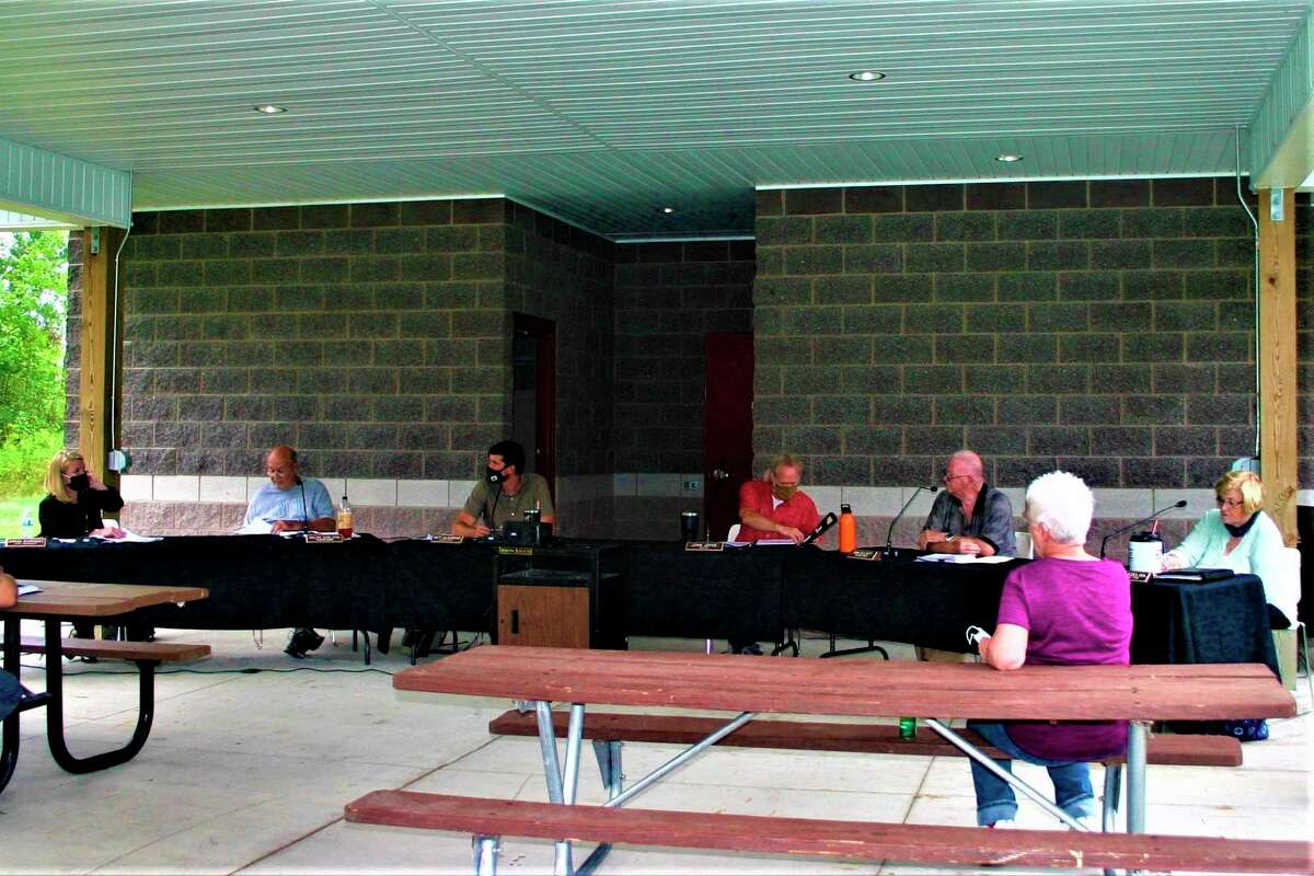 Evart City Council met outdoors at the Riverside East pavilion for their regular meeting on Aug. 24. (Herald Review photo/Cathie Crew)