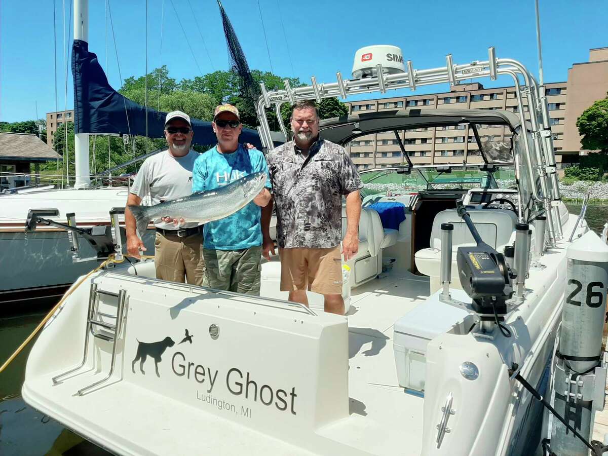 Mark Sochocki (center) and his fishing mates celebrate their success. (Courtesy photo)