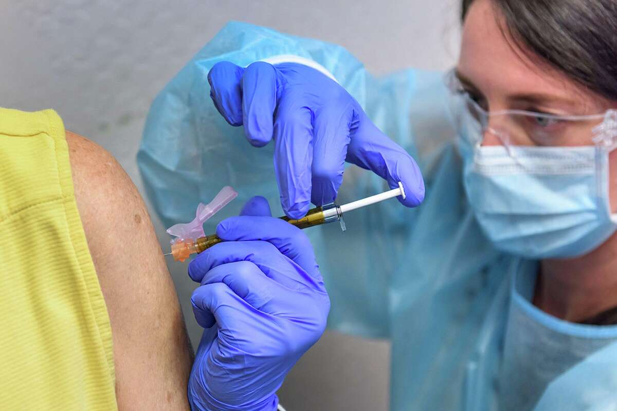 Audrey Kuehl, a study coordinator at the Clinical Research Institute of Southern Oregon, inoculates Trish Malone with Moderna's COVID-19 vaccine. “The one thing that you would not want to see with a vaccine is getting an [emergency use authorization] before you have a signal of efficacy,” he told Reuters, warning that a prematurely released vaccine could do more damage than good. “One of the potential dangers if you prematurely let a vaccine out is that it would make it difficult, if not impossible, for the other vaccines to enroll people in their trial." Translation: It’s going to have to be done in a deliberate way. But, even then, as Yale epidemiologist Virginia Pitzer said a few months ago, a vaccine is “not necessarily going to make everything go away so that it's never a problem.” She said that for a vaccine to help us reach the herd immunity threshold, it would have to have 67 percent efficacy — meaning that it would have to be 67 percent effective at stopping the disease and administered to 100 percent of the population, be 100 percent effective and administered to 67 percent of population, or somewhere between the two.  