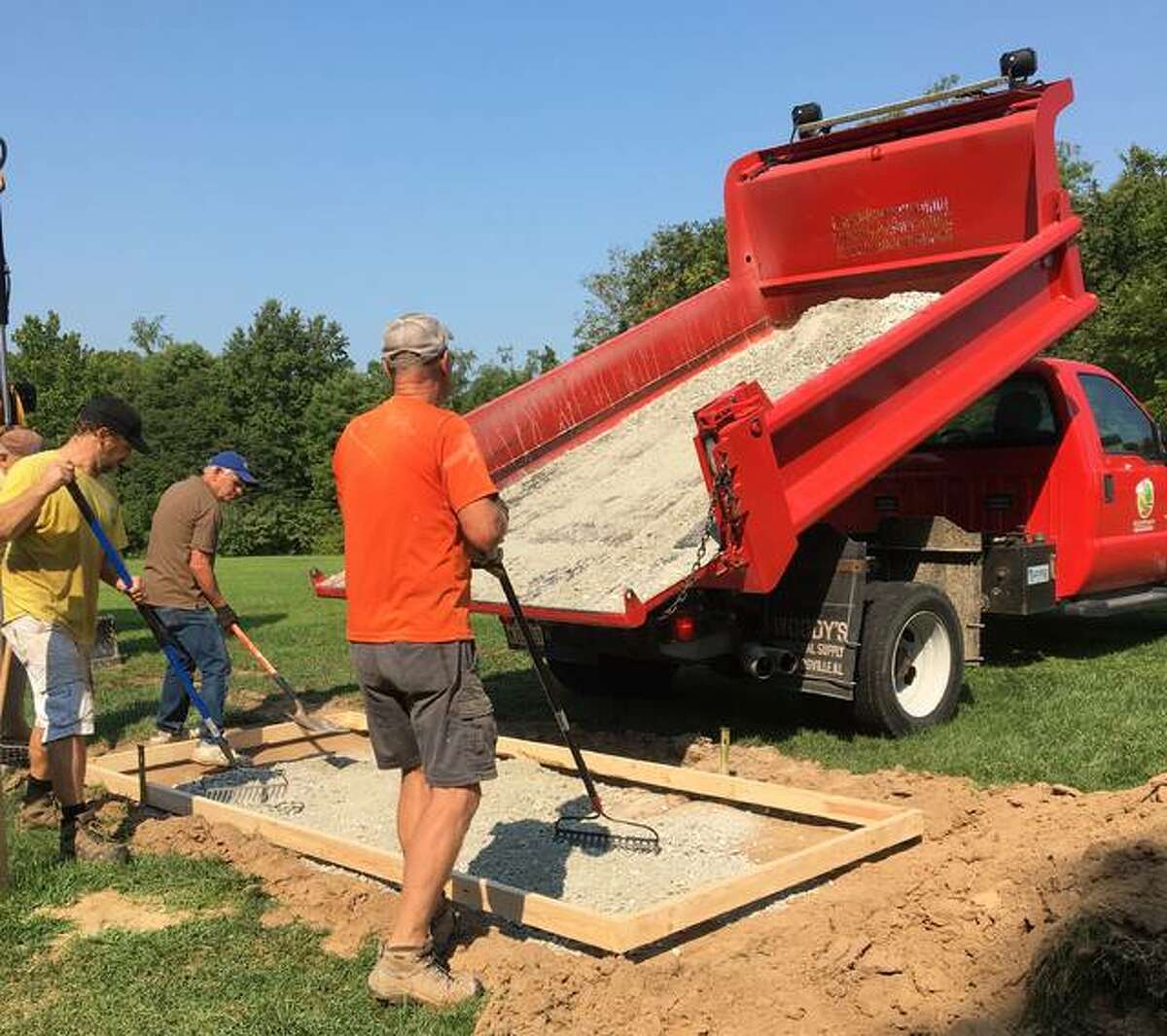 Alton-Godrey Rotary Club members Dennis Wilson, Jim White and Tracy Shaffer prepare a disc golf tee box at La Vista Park in Godfrey. Work will continue on the 18-hole course into September.