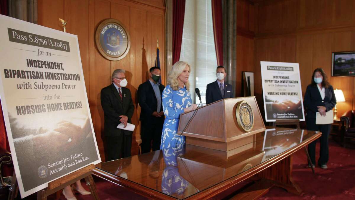 Janice Dean of Fox News, center, joins Assemblyman Ron Kim, a Democrat from Queens, and lawmakers during a press conference calling for an independent investigation into nursing home deaths.