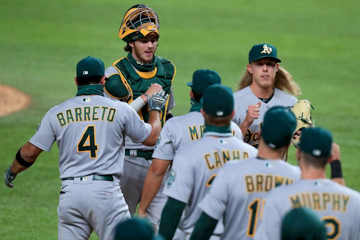 ARLINGTON, TEXAS - AUGUST 25: Jonah Heim #37 of the Oakland Athletics celebrates with Jordan Weems #70 of the Oakland Athletics after the Oakland Athletics beat the Texas Rangers 10-3 at Globe Life Field on August 25, 2020 in Arlington, Texas. (Photo by Tom Pennington/Getty Images)