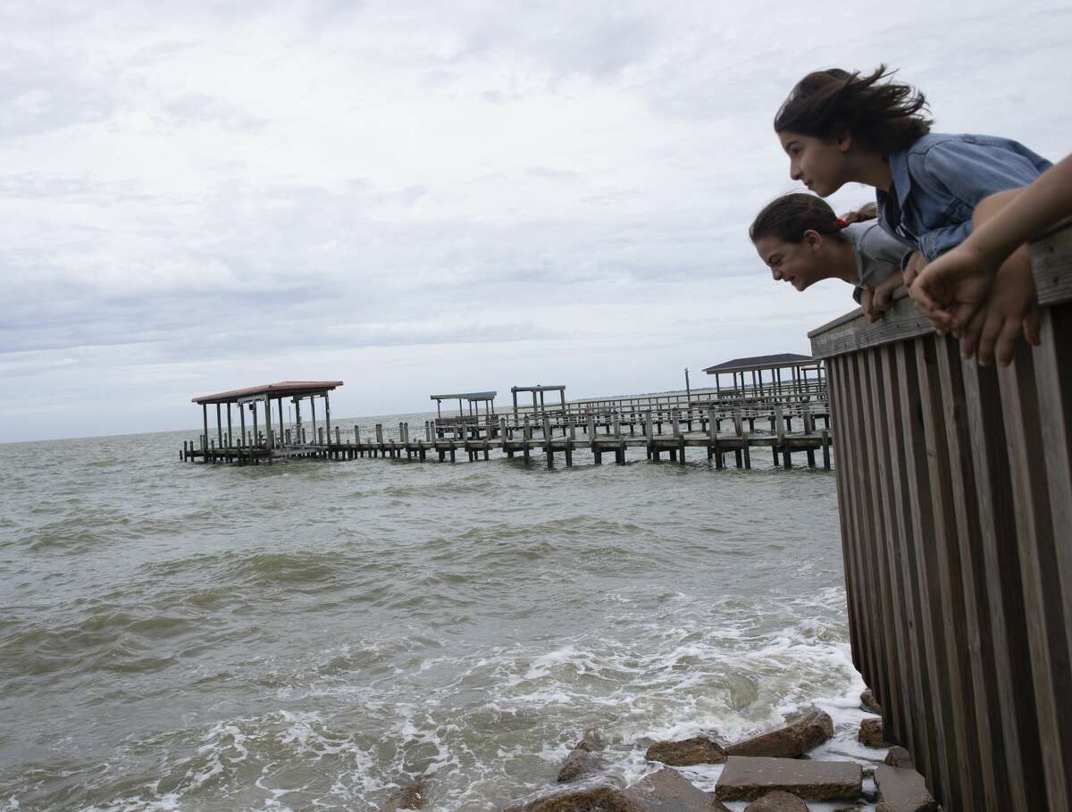 Sisters Kindah Abuayyash, 9, and Haya Abuayyash, 10, are excited to watch the waves with their mom and siblings before Hurricane Laura makes landfall Wednesday, Aug. 26, 2020, in Kemah.