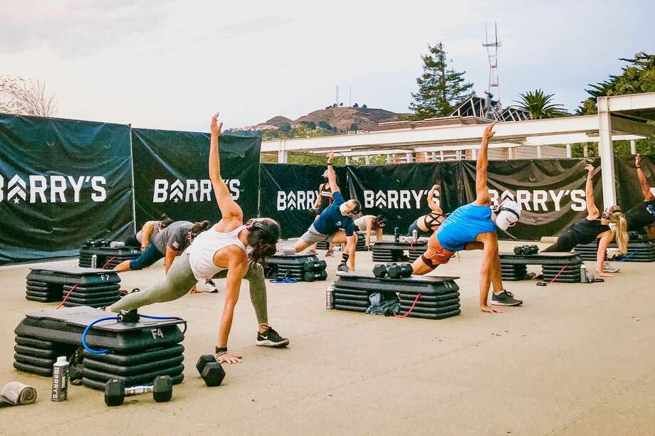 People take part in a Barry's Bootcamp outdoors class at the Castro rooftop car lot in San Francisco. Photo: Barry's Bootcamp
