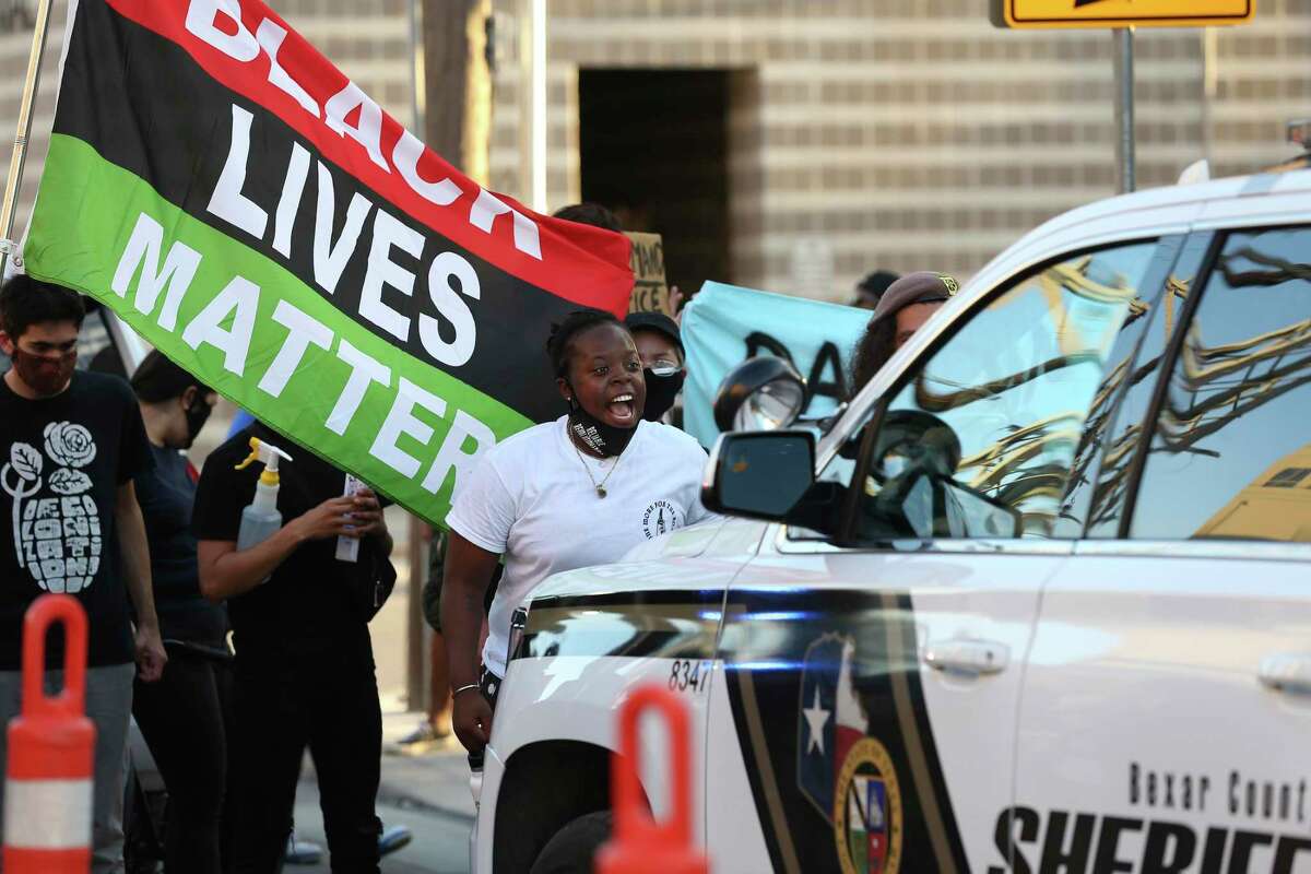 Protesters surround a Bexar County sheriff’s unit outside the jail. The group gathered Wednesday to protest the death of Damian Lamar Daniels, who was shot during a confrontation with deputies.