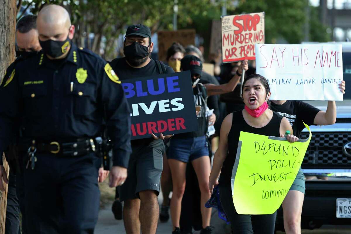 Protesters follow Bexar County Sheriff Javier Salazar after he tried talking with them during a protest outside the jail in August. The group was protesting the killing of Damien Lamar Daniels, a Black veteran shot by sheriff’s Deputy John Rodriguez.