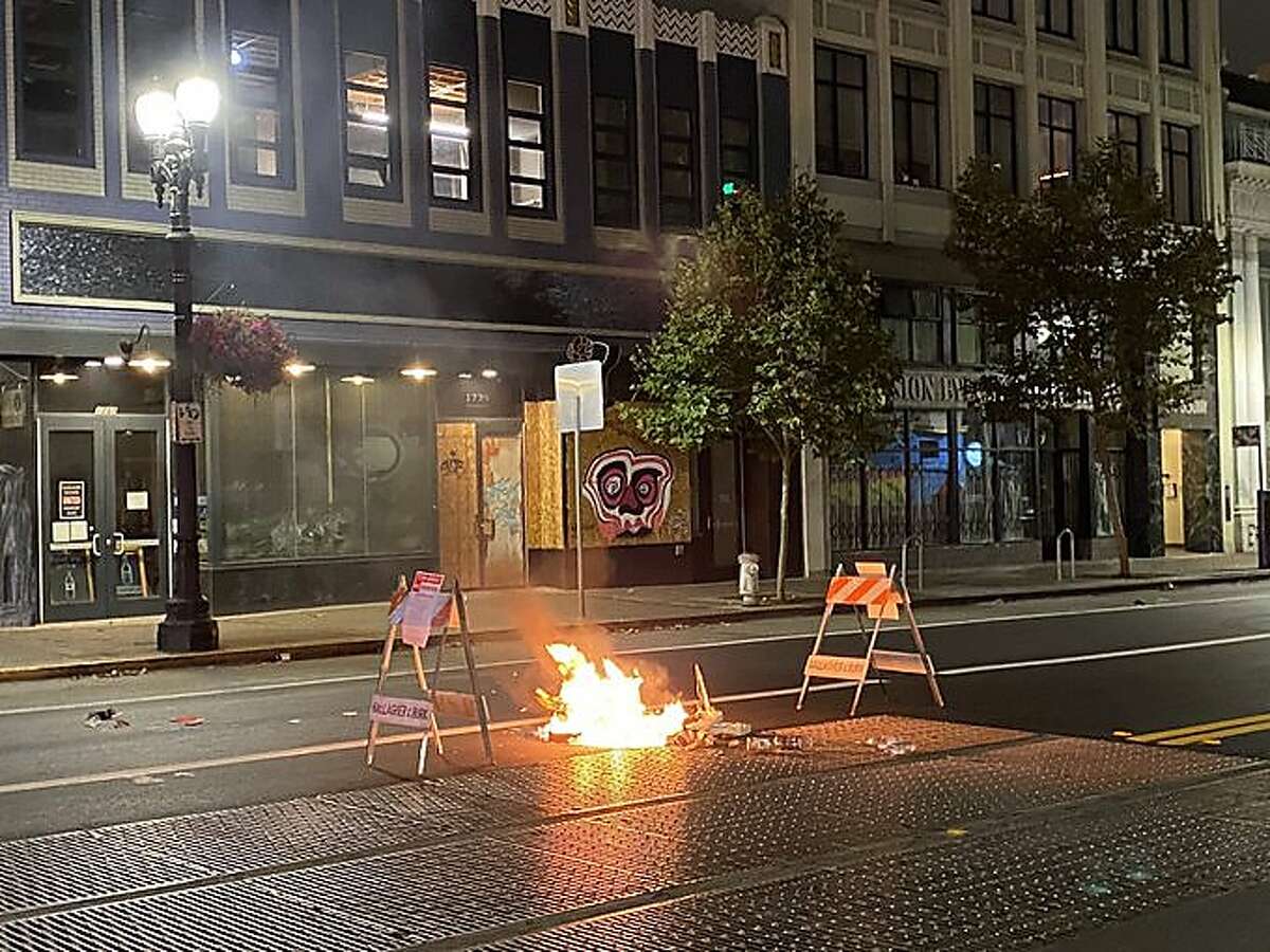 Photos and video shared on the Oakland Police Department Twitter page shows tipped over trashcans sprawled in the middle of the street, and two small fires surrounded by traffic cones on Wednesday, Aug. 26, 2020.