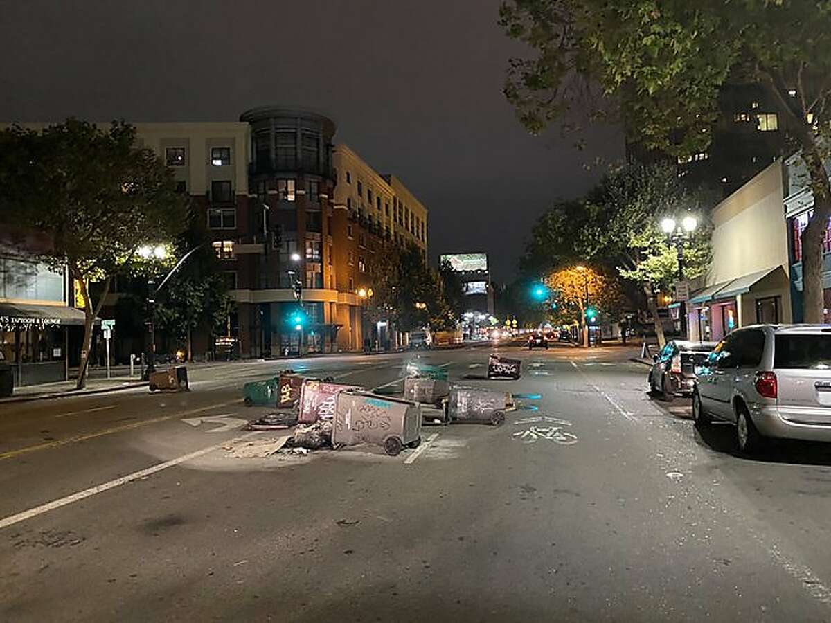 Photos and video shared on the Oakland Police Department Twitter page shows tipped over trashcans sprawled in the middle of the street, and two small fires surrounded by traffic cones on Wednesday, Aug. 26, 2020. Police said officers and firefighters were responding to multiple reports of trashcans set ablaze and fireworks set off after a demonstration in Oakland Wednesday night.