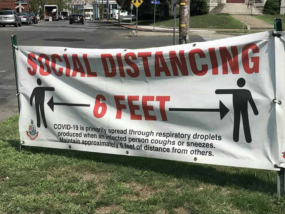 A sign advising residents to maintain 6 feet of distance, seen in Stamford. Photo: Jordan Fenster / Hearst Connecticut Media
