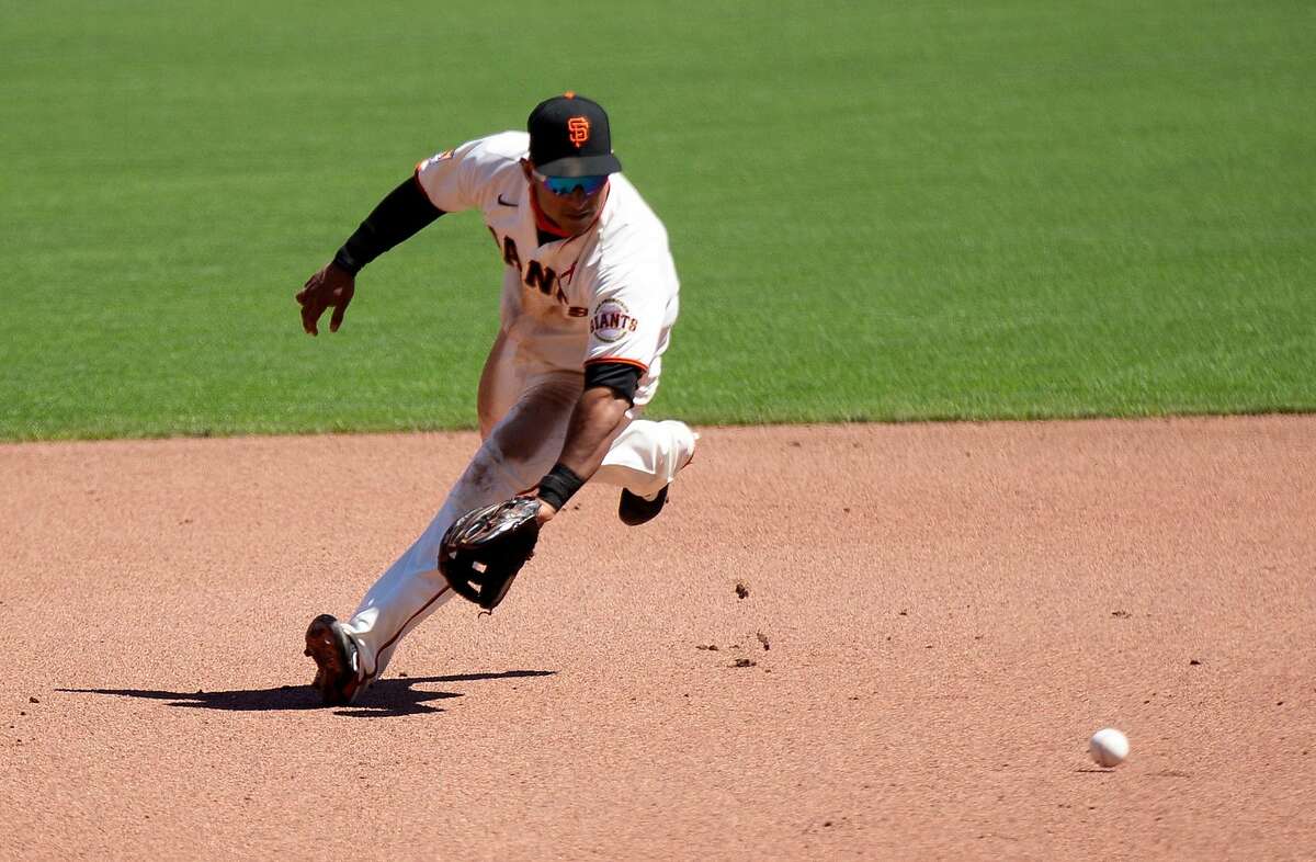 San Francisco Giants shortstop Donovan Solano (7) goes hard to his right for Los Angeles Dodgers Los Angeles Dodgers designated hitter Joc Pederson�s infield single during the fourth inning of a baseball game on Thursday, Aug. 27, 2020 in San Francisco, Calif.