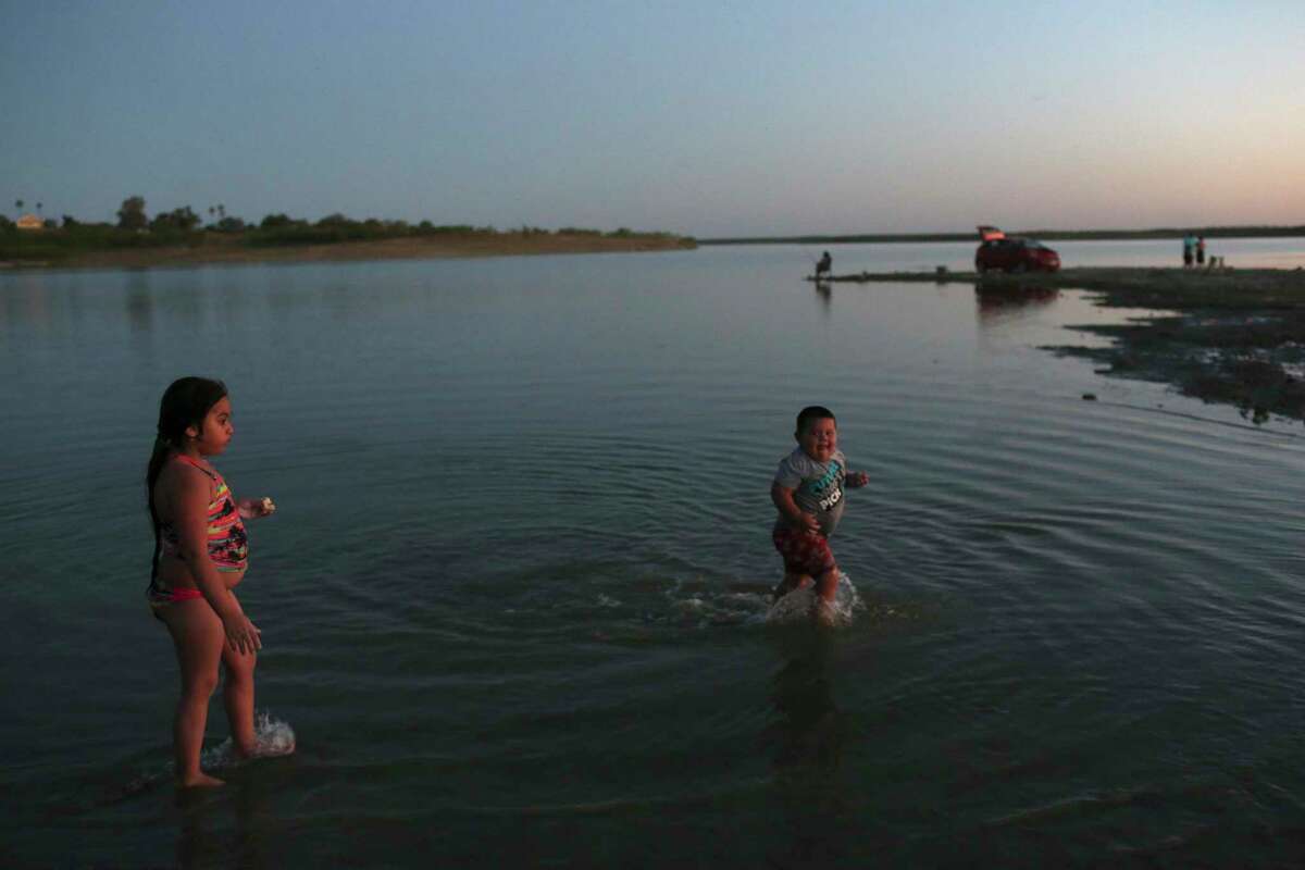Kyvelie Lopez, 5, and Ernesto Alonzo Almaguer, 3, play in the waters of Falcon Lake in Zapata. The lake has dropped to 26 percent of its capacity.