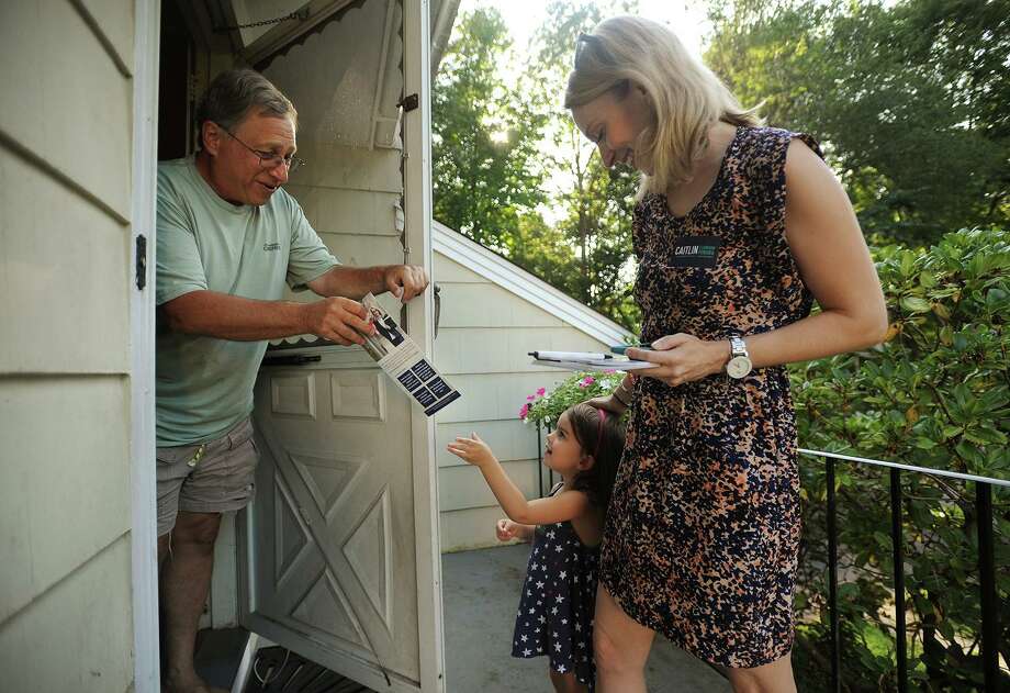 Rich Jacobs, of Fairfield, is handed campaign literature by Parker Pereira, 3, daughter of candidate for Fairfield state representative Caitlin Clarkson Pereira, during an afternoon of campaigning on Limerick Road in Fairfield, Conn. on Wednesday, August 22, 2018. Clarkson Pereira was denied her request to the State Elections Enforcement Commission to use her campaign funds to pay for child care. Photo: Brian A. Pounds / Hearst Connecticut Media / Connecticut Post
