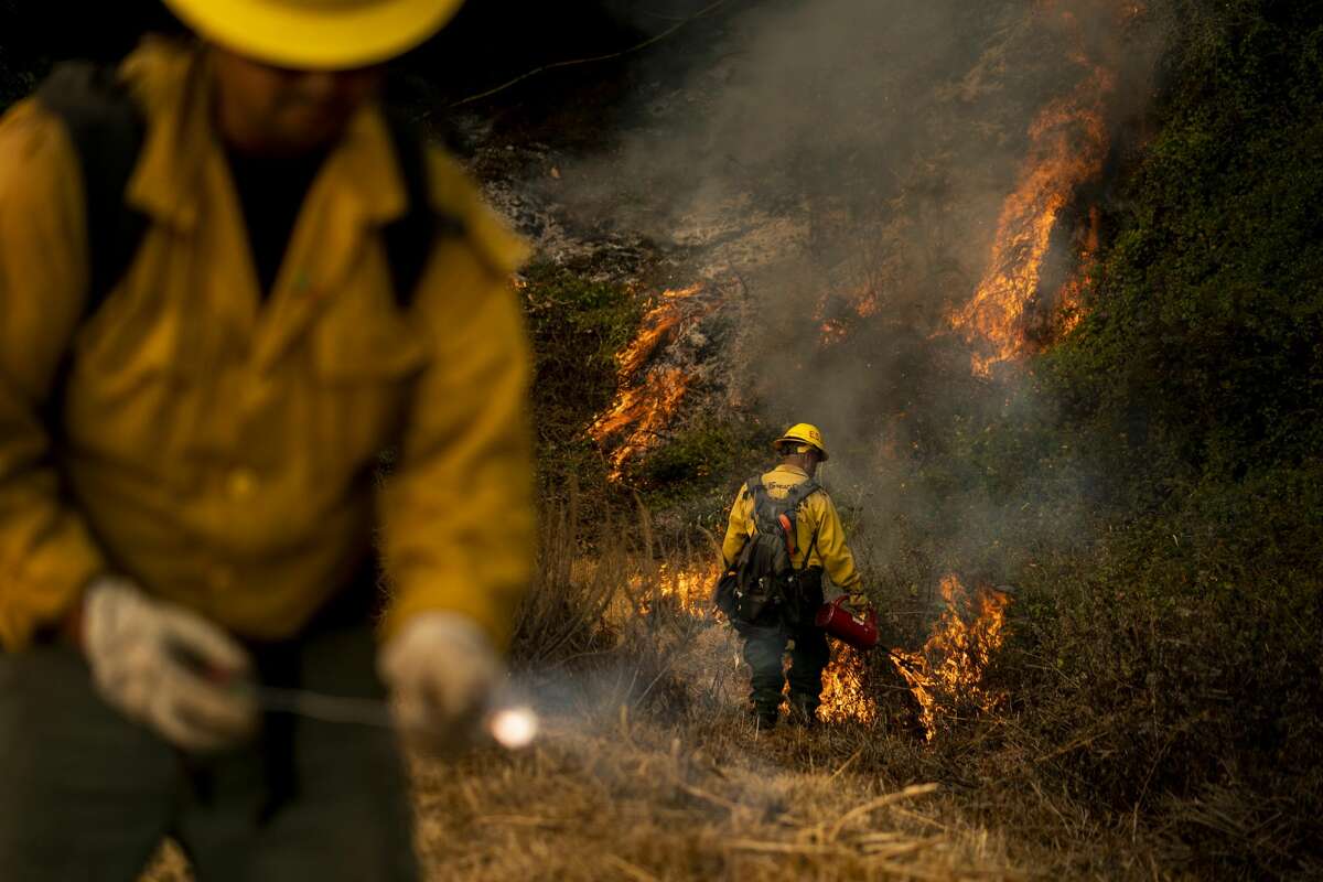 Battling the Dolan Fire along the central California coast, Los Padres National Forest fire fighters implement a "back-fire" method to burn off underbrush to protect residential structures in Big Sur, California on Saturday August 22, 2020.
