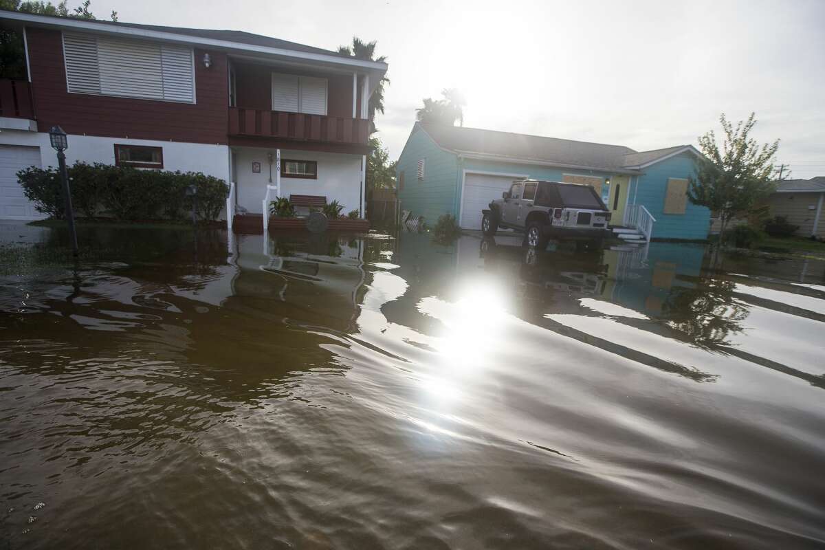 Water rises close to homes from street flooding following landfall of Hurricane Laura on Thursday, Aug. 27, 2020 in Galveston. The island city was spared after came ashore east of the Texas/Louisiana border overnight.
