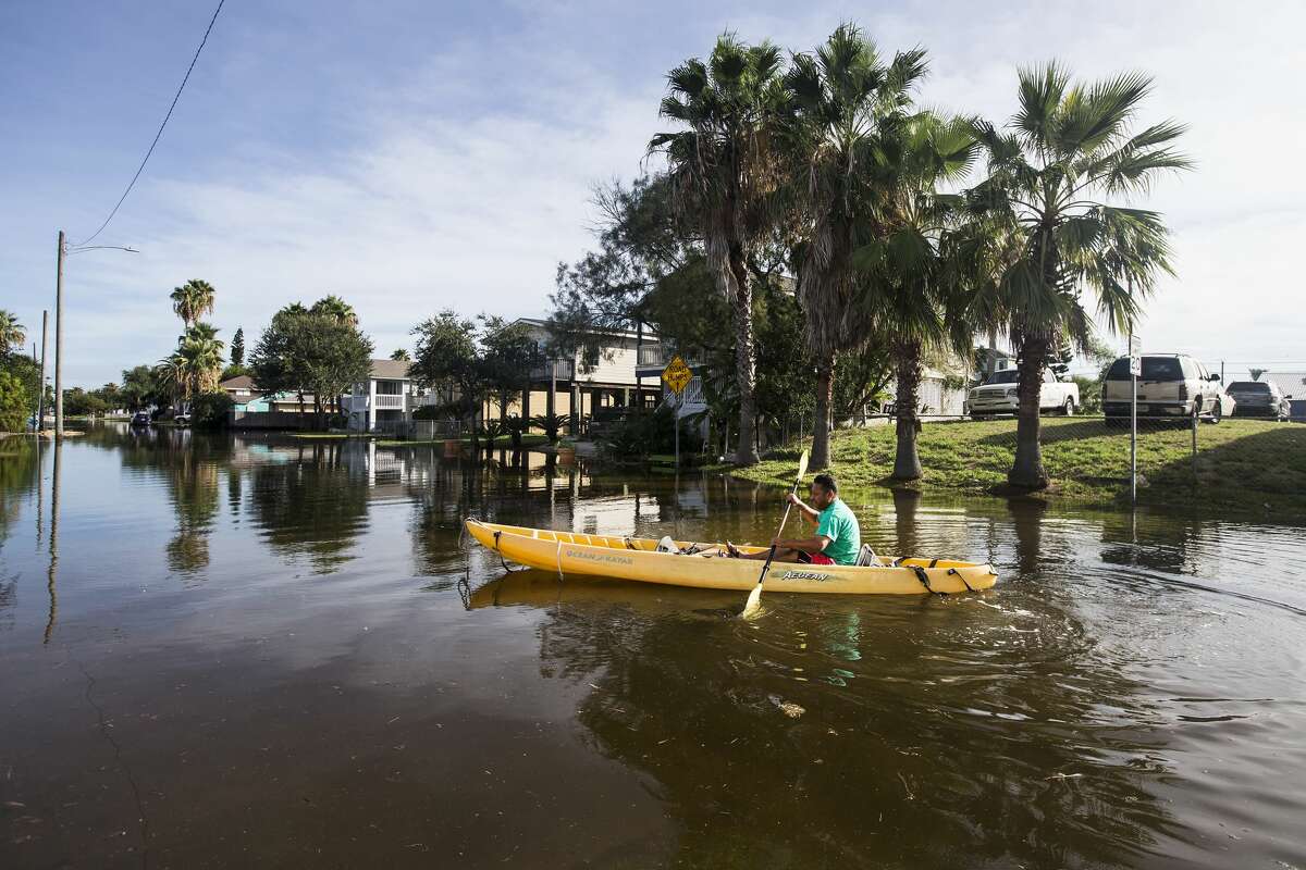 Martin Almanza paddles a canoe through some street flooding following landfall of Hurricane Laura on Thursday, Aug. 27, 2020 in Galveston. The island city was spared after came ashore east of the Texas/Louisiana border overnight.