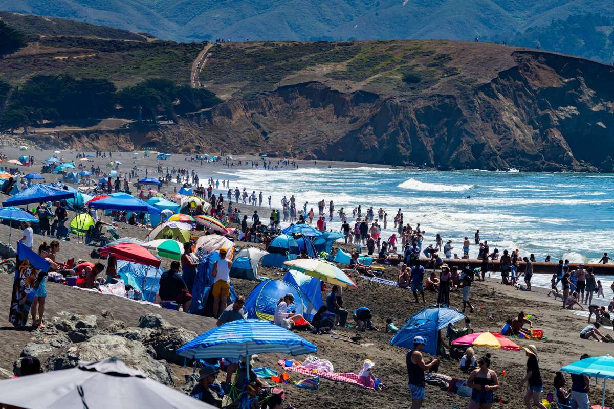 People flock to Sharp Park Beach in Pacifica on Aug. 15, 2020, as temperatures hit 90 degrees. Some think this is too crowded for safety during a pandemic. Pacifica plans to close beaches over the Labor Day weekend. (Photo courtesy of David Chamberlin.)