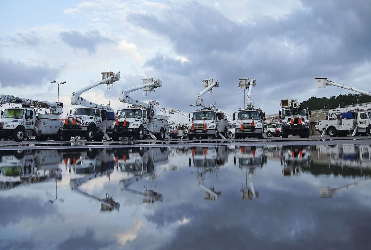 Utility trucks gather in Orange, Texas as recovery efforts continue following Hurricane Laura on Friday, Aug. 28, 2020.