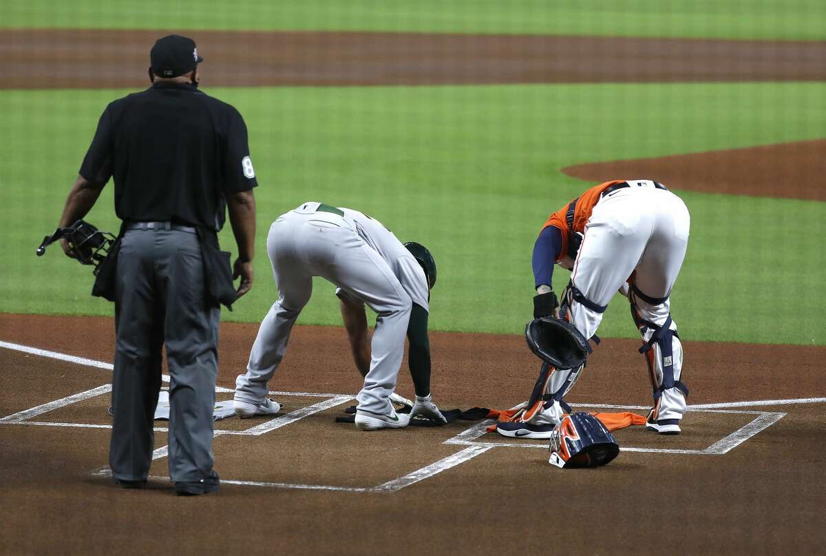 Houston Astros catcher Martin Maldonado (42) and Oakland Athletics shortstop Marcus Semien (42) place jerseys at home plate with the number "42 on them along with a t-shirt that read "Black Lives Matter" during the first inning of an MLB baseball game at Minute Maid Park, Friday, August 28, 2020, in Houston. All players for this game are wearing number 42 tonight, for Jackie Robinson Day. Moments later, all players from both teams exited the field to protest racial injustice and police brutality. All players for this game are wearing number 42 tonight, for Jackie Robinson Day.