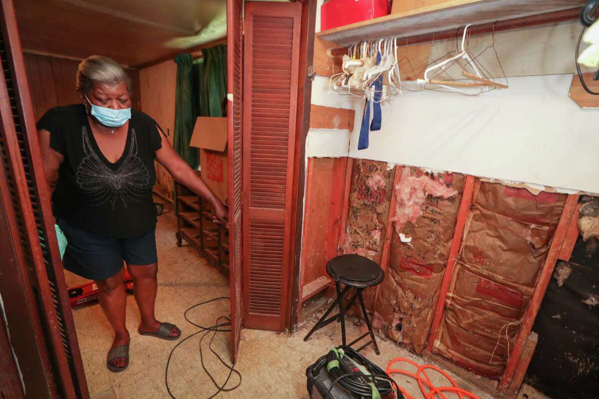 Juanita Hall in her home Friday, Aug. 28, 2020, in Houston. About four months before Hurricane Harvey, Juanita Hall's mother died of a heart attack, leaving Juanita and her brother with her house. Harvey then brought extensive damage to the home — damage that Hall has been unable to fix through the city's recovery program, which has been plagued by delays.