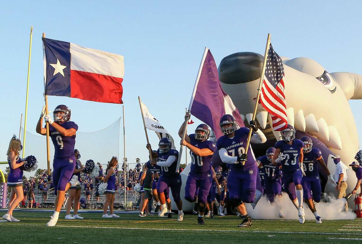 Boerne's John Warden, left, and the rest of the Greyhounds run onto the field before the start of their season opening game with Beeville at Boerne ISD Stadium on Wednesday, Aug. 28, 2020.