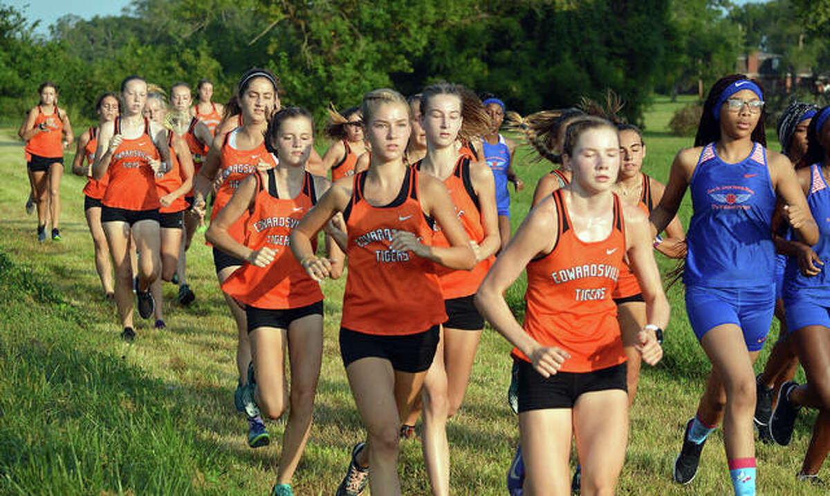 The Edwardsville girls cross country team takes off from the finish line during Saturday’s season-opening dual meet against East St. Louis at Frank Holten State Park.