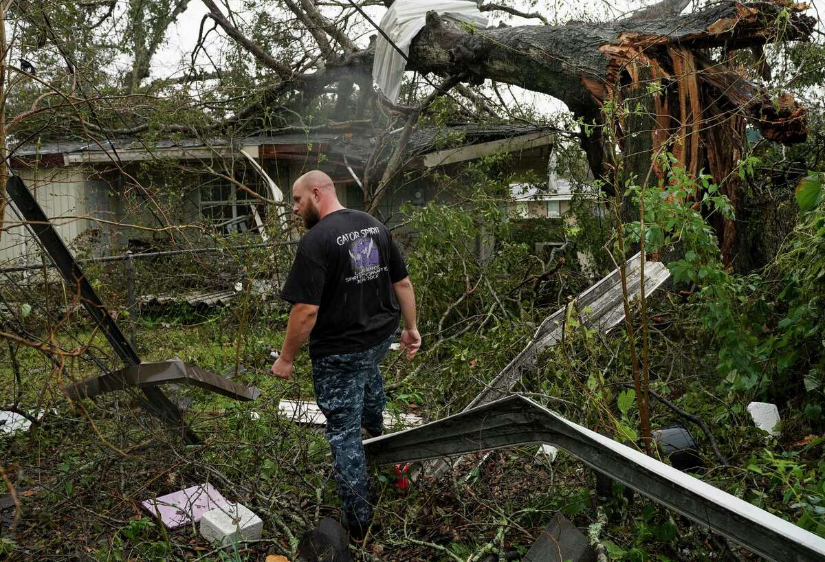 Jared Johnson checks up on a friend's home, during the aftermath of Hurricane Laura, Friday, Aug. 28, 2020, in Lake Charles, La.
