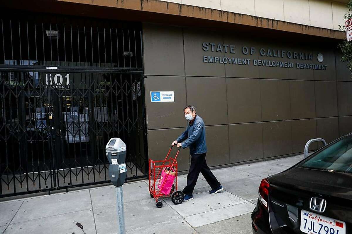 A man walks by the Employment Development Department office on Monday, June 15, 2020 in San Francisco, California.