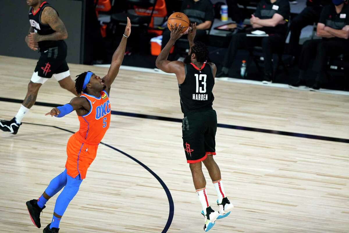 Houston Rockets' James Harden (13) shoots as Oklahoma City Thunder's Luguentz Dort (5) defends during the first half of an NBA basketball first round playoff game Saturday, Aug. 29, 2020, in Lake Buena Vista, Fla. (AP Photo/Ashley Landis)