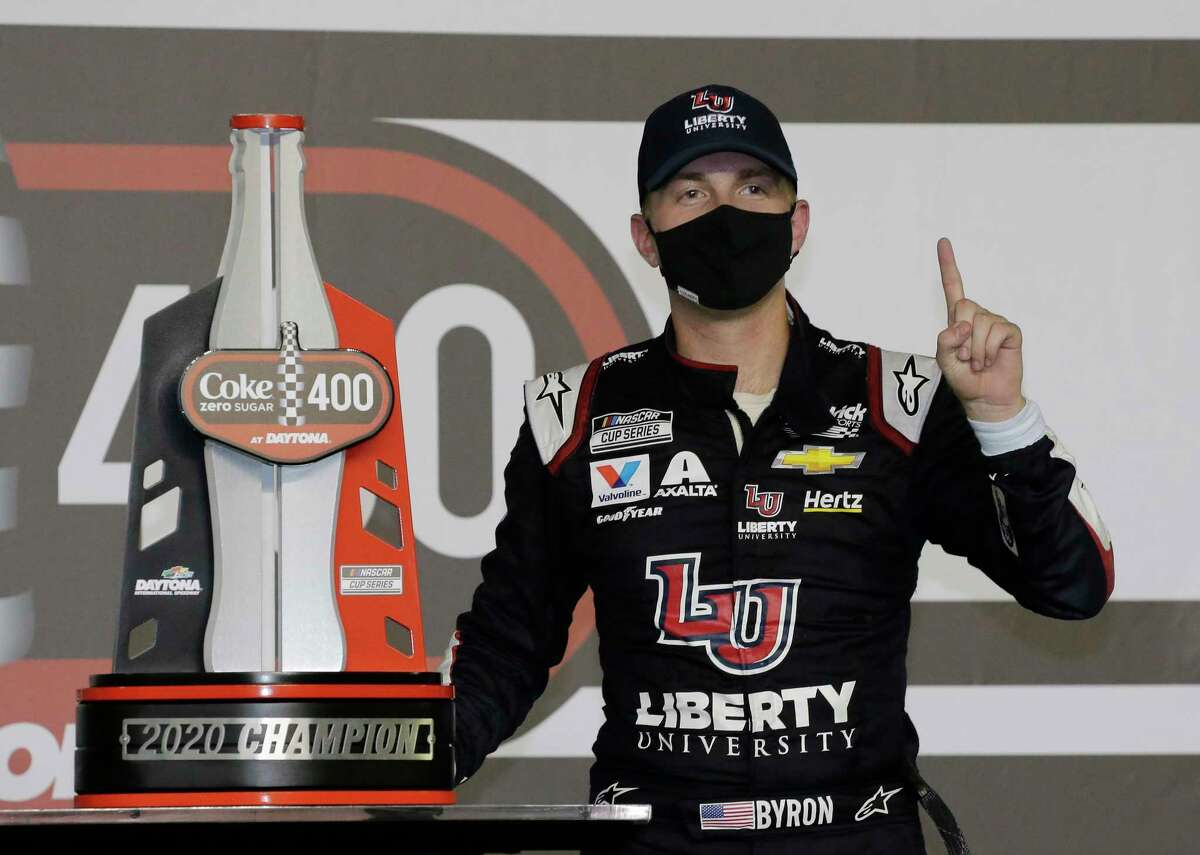 William Byron stands with his trophy in Victory Lane after winning the NASCAR Cup Series auto race at Daytona International Speedway, Saturday, Aug. 29, 2020, in Daytona Beach, Fla. (AP Photo/Terry Renna)