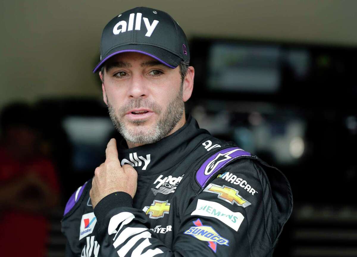 FILE - In this Feb. 16, 2019, file photo, Jimmie Johnson leaves his garage after NASCAR auto racing practice at Daytona International Speedway in Daytona Beach, Fla. NASCAR's season officially opens Sunday, Feb. 16, 2020, with the Daytona 500 at Daytona International Speedway. (AP Photo/Terry Renna, File)