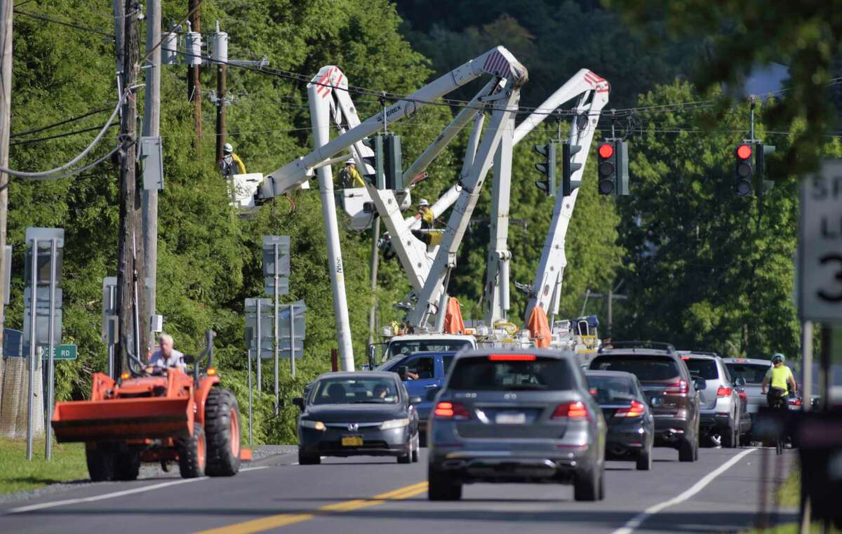 Line crews repair electrical lines near the intersection of Routes 40 and 67 on Sunday, Aug. 30, 2020, in Schaghticoke, N.Y. (Paul Buckowski/Times Union)