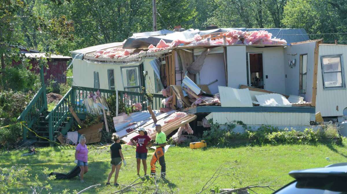 People clean up damage from a storm at a home on McDermott Road on Sunday, Aug. 30, 2020, in Stillwater, N.Y. An unusual series tornadoes hit the Hudson Valley in November 2021. (Paul Buckowski/Times Union)