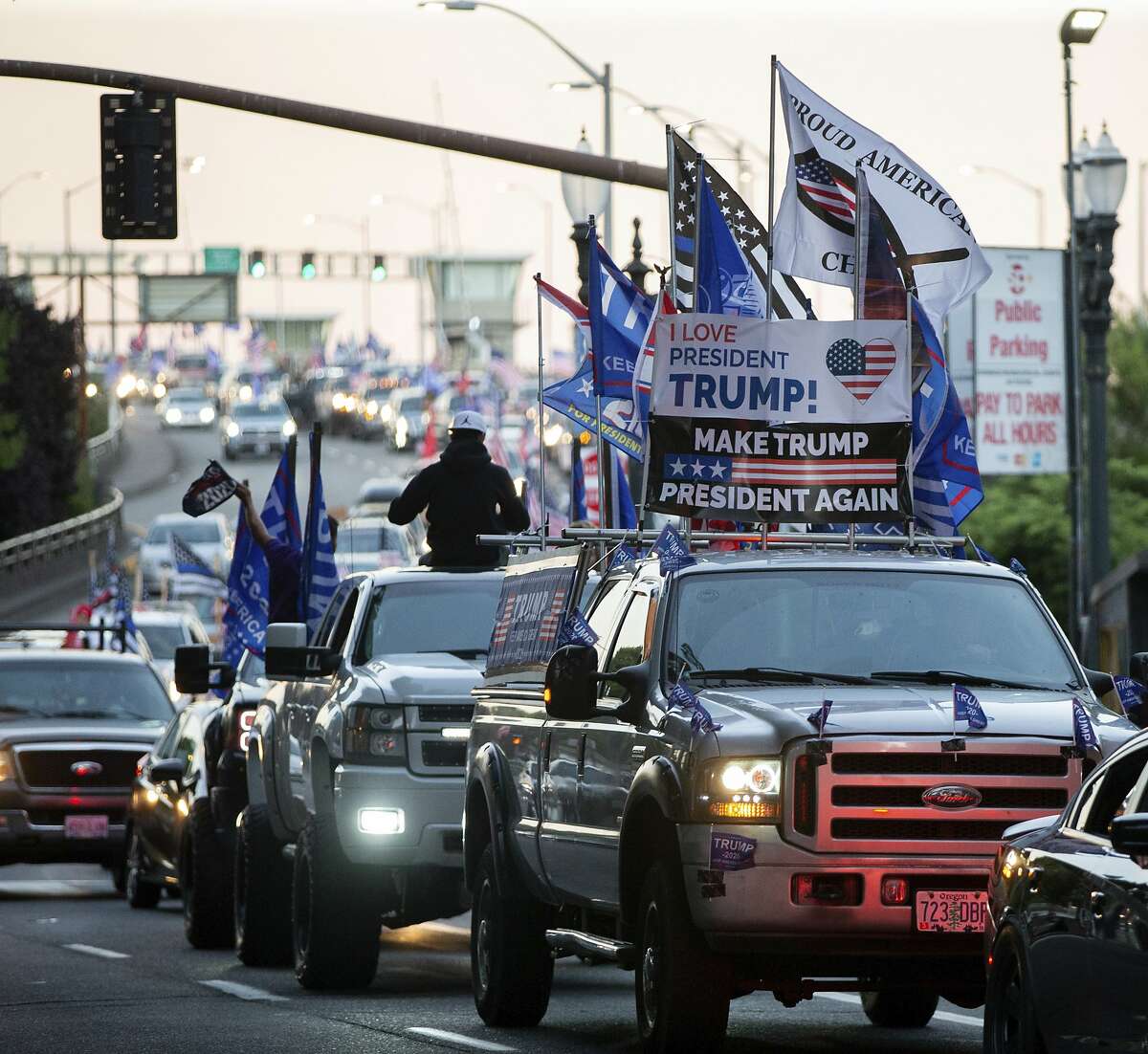 Trump supporters participate in a massive caravan that traveled through Portland, Ore., on Saturday afternoon Aug. 29, 2020. In the course of the demonstration, one man was shot and killed in downtown Portland. (Mark Graves/The Oregonian via AP)