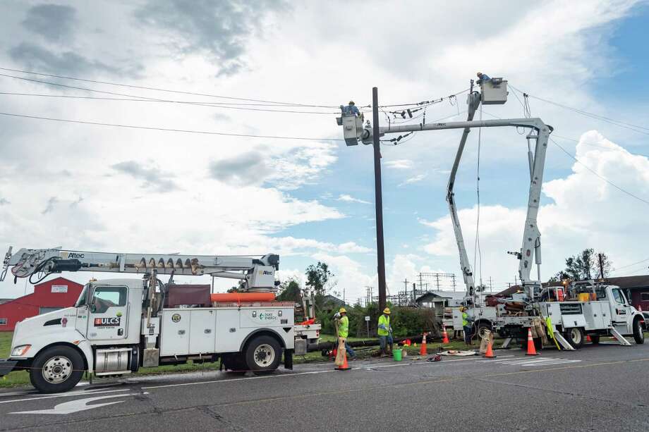 Electrical linemen at W. Green Avenue and Simmons Drive in Orange work to restore power to local residents. On Friday, the work of recovering from Hurricane Laura continued for many folks, some of whom had evacuated to avoid the storm. Photo made on August 28, 2020. Fran Ruchalski/The Enterprise Photo: Fran Ruchalski, The Enterprise / The Enterprise / © 2020 The Beaumont Enterprise