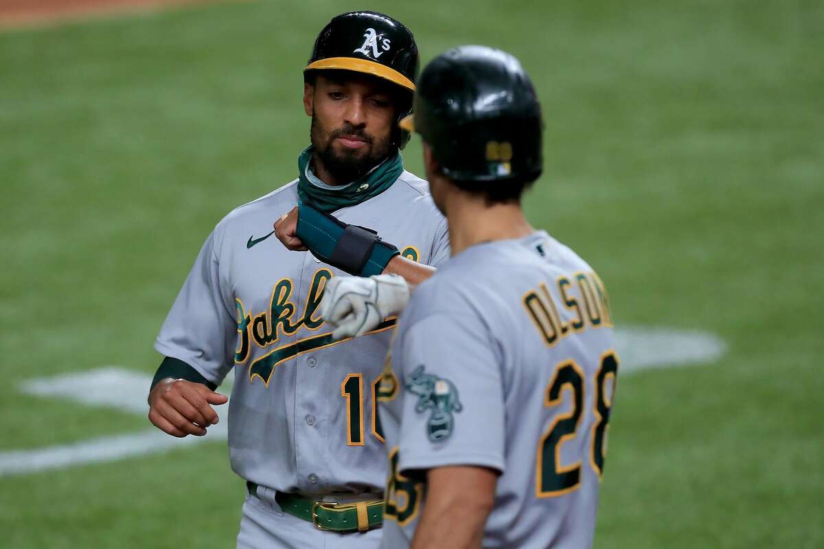 ARLINGTON, TEXAS - AUGUST 26: Marcus Semien #10 of the Oakland Athletics celebrates after scoring against the Texas Rangers on a RBI single hit by Stephen Piscotty #25 of the Oakland Athletics in the top of the sixth inning at Globe Life Field on August 26, 2020 in Arlington, Texas. (Photo by Tom Pennington/Getty Images)
