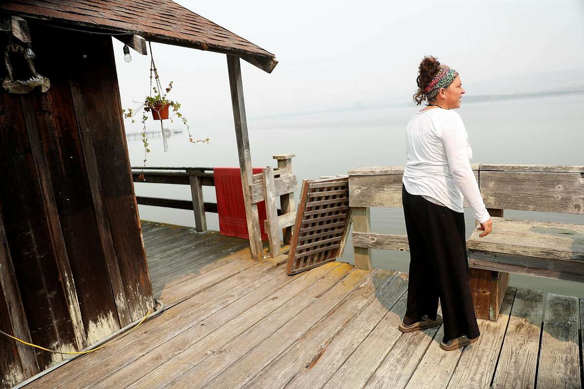 Woodward Fire evacuee Madeline Nieto Hope looks out over Tomales Bay from her boathouse in Inverness, Calif., on Sunday, August 30, 2020.