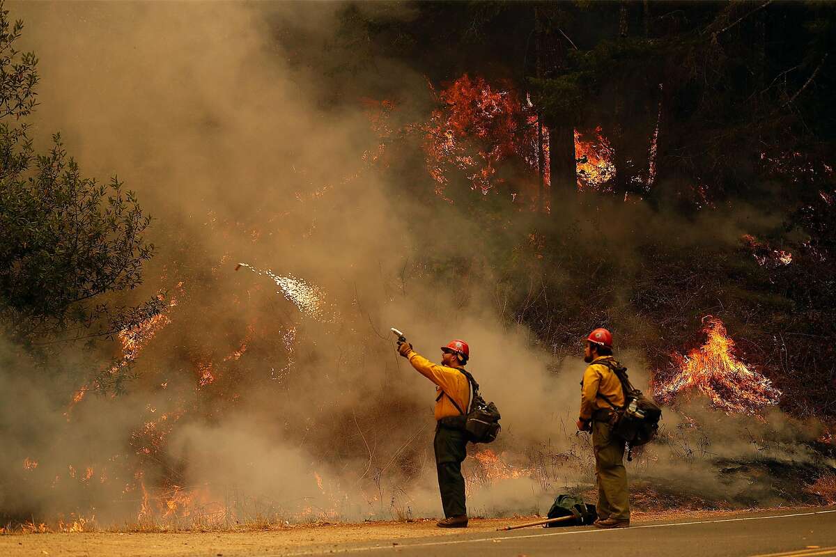 A US Forest Service firefighter shoots a fire igniter during firing operation along Limantour Road while Woodward Fire burns in Point Reyes National Seashore in Marin County in California on Sunday, August 30, 2020.