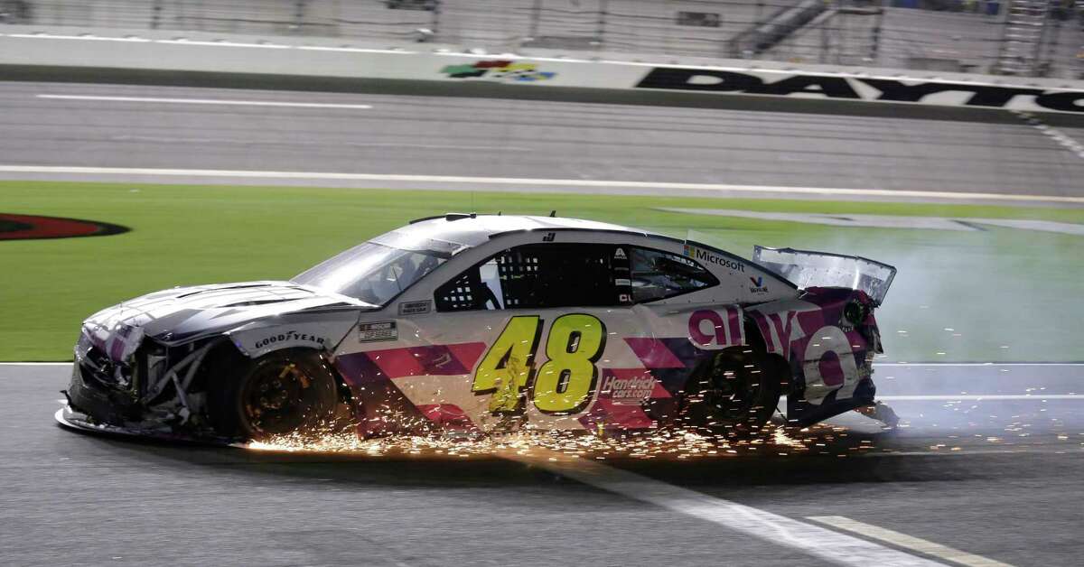 Jimmie Johnson drives his damaged car on pit road during the NASCAR Cup Series auto race at Daytona International Speedway, Saturday, Aug. 29, 2020, in Daytona Beach, Fla. (AP Photo/Terry Renna)