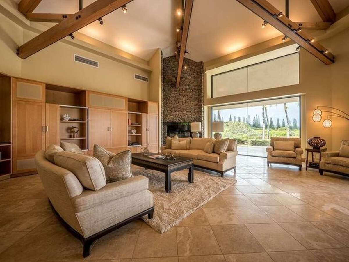 Living room with beams and stone fireplace Over the years, that has been whittled down, to $6.9 million in 2012 and then two years later, to $5.9 million. In 2016, the home was listed for $5.49 million. Last summer, the price dropped to $4.7 million. It was relisted this week at that same amount.