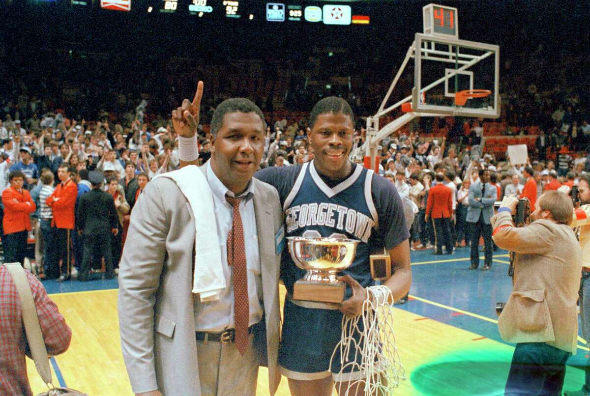 FILE - In this March 9, 1985, file photo, Georgetown NCAA college basketball head coach John Thompson poses with player Patrick Ewing. Location unknown. John Thompson, the imposing Hall of Famer who turned Georgetown into a “Hoya Paranoia” powerhouse and became the first Black coach to lead a team to the NCAA men’s basketball championship, has died. He was 78 His death was announced in a family statement Monday., Aug. 31, 2020. No details were disclosed.(AP Photo/File)