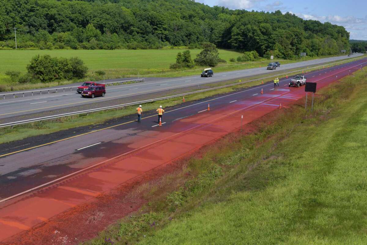 Crews work washing off a powdered chemical that spilled on the westbound lane of Interstate 90 near exit 26 on Monday, August 31, 2020, in Rotterdam, N.Y. State Police said that a tractor trailer hauling a load of the dry chemical, possibly iron oxide, spilled the substance on the thruway. (Paul Buckowski/Times Union)