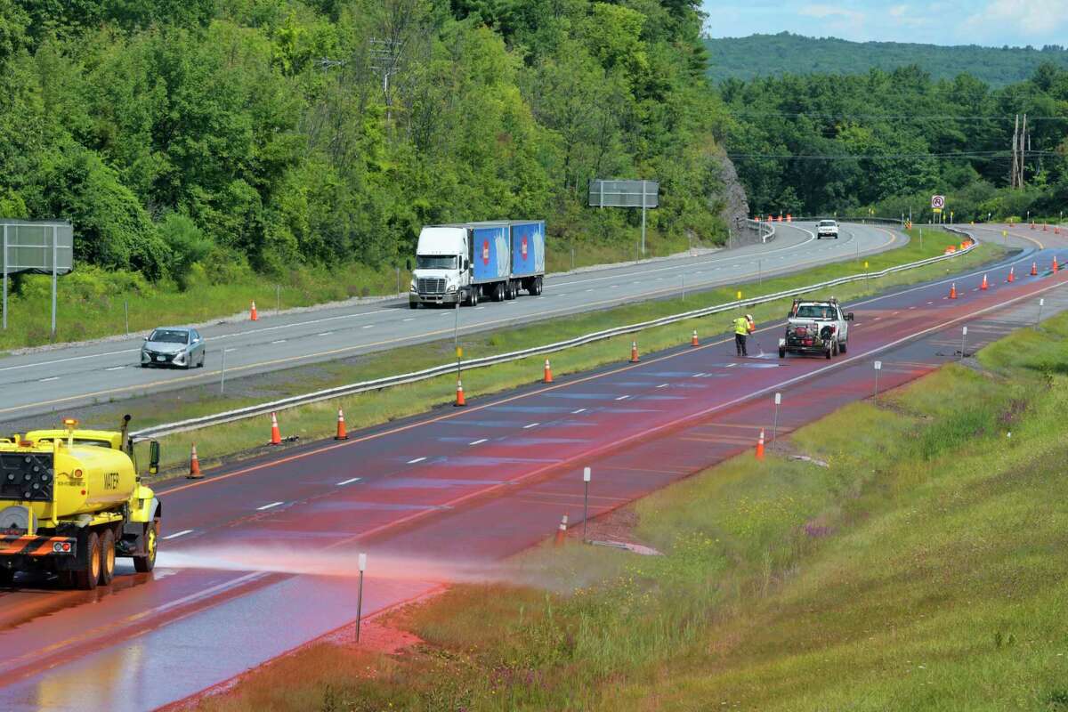 Crews work washing off a powdered chemical that spilled on the westbound lane of Interstate 90 near exit 26 on Monday, August 31, 2020, in Rotterdam, N.Y. State Police said that a tractor trailer hauling a load of the dry chemical, possibly iron oxide, spilled the substance on the thruway. (Paul Buckowski/Times Union)