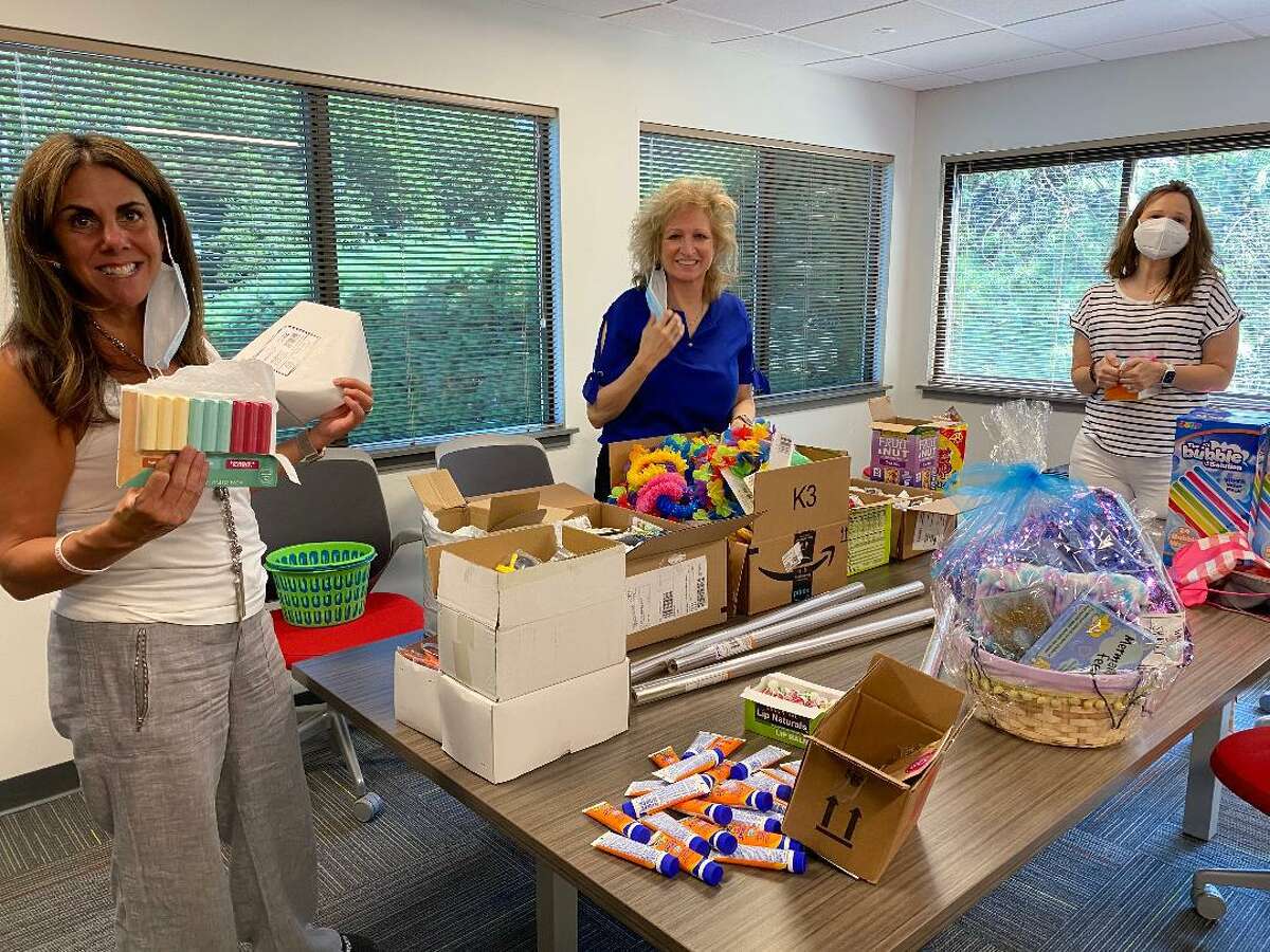 Kim DiMatteo, left, branch manager at DiMatteo Insurance in Shelton, helps create summer beach baskets that the firm delivered to shelters in Norwalk and Stamford. The back-to-school themed baskets were donated by DiMatteo Financial, DiMatteo Insurance and ACBI Insurance, all located in Shelton. DiMatteo is pictured with fellow employees Linda Ayles of Monroe, center, and Jamie Nickerson of New Milford.