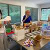 Kim DiMatteo, left, branch manager at DiMatteo Insurance in Shelton, helps create summer beach baskets that the firm delivered to shelters in Norwalk and Stamford. The back-to-school themed baskets were donated by DiMatteo Financial, DiMatteo Insurance and ACBI Insurance, all located in Shelton. DiMatteo is pictured with fellow employees Linda Ayles of Monroe, center, and Jamie Nickerson of New Milford.