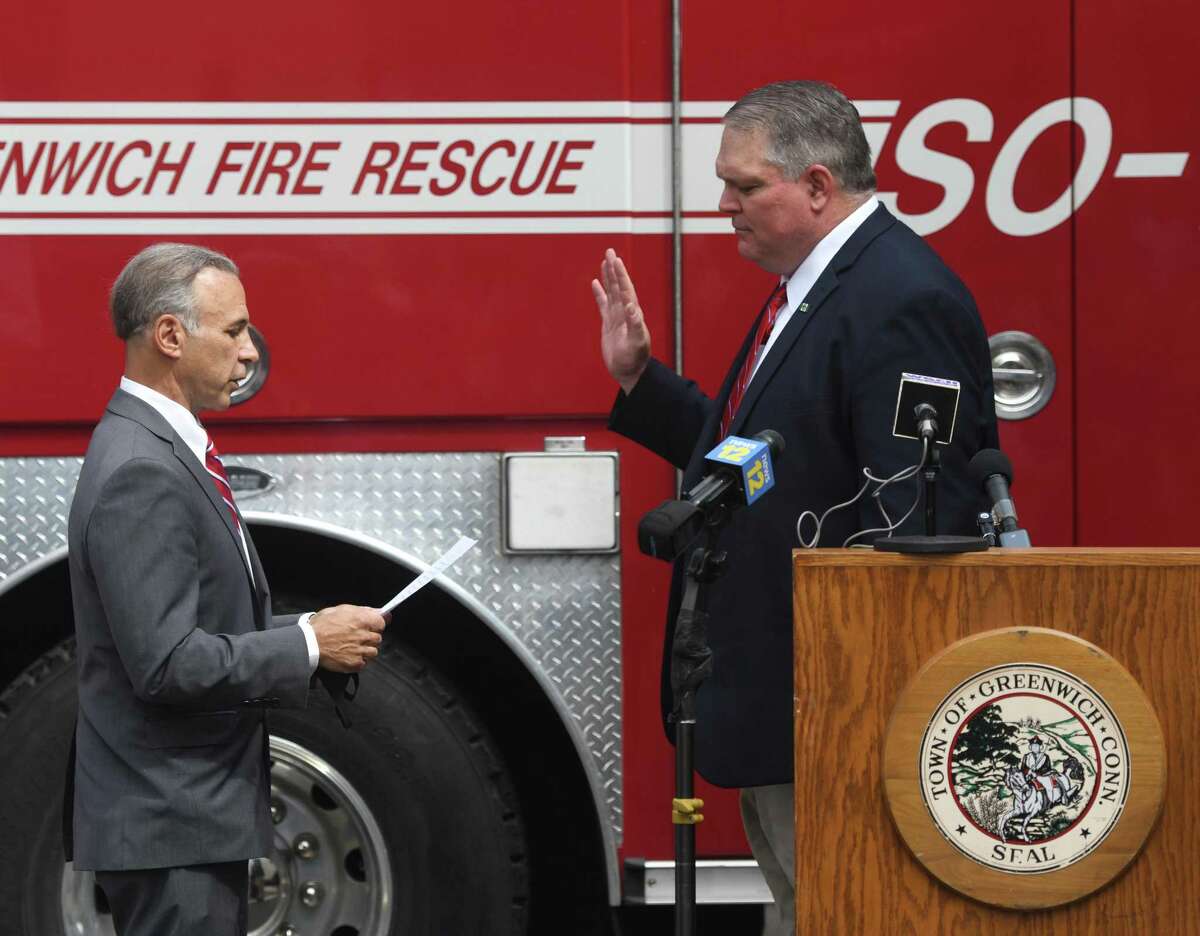 Incoming Fire Chief Joseph McHugh, right, is sworn in by First Selctman and Fire Commissioner Fred Camillo at the Public Safety Complex in Greenwich, Conn. Monday, Aug. 31, 2020. McHugh grew up in Greenwich and spent most of his career with the FDNY. The incoming Fire Chief will succeed Peter Siecienski, who retired in May, and begin his role on Sept. 14.