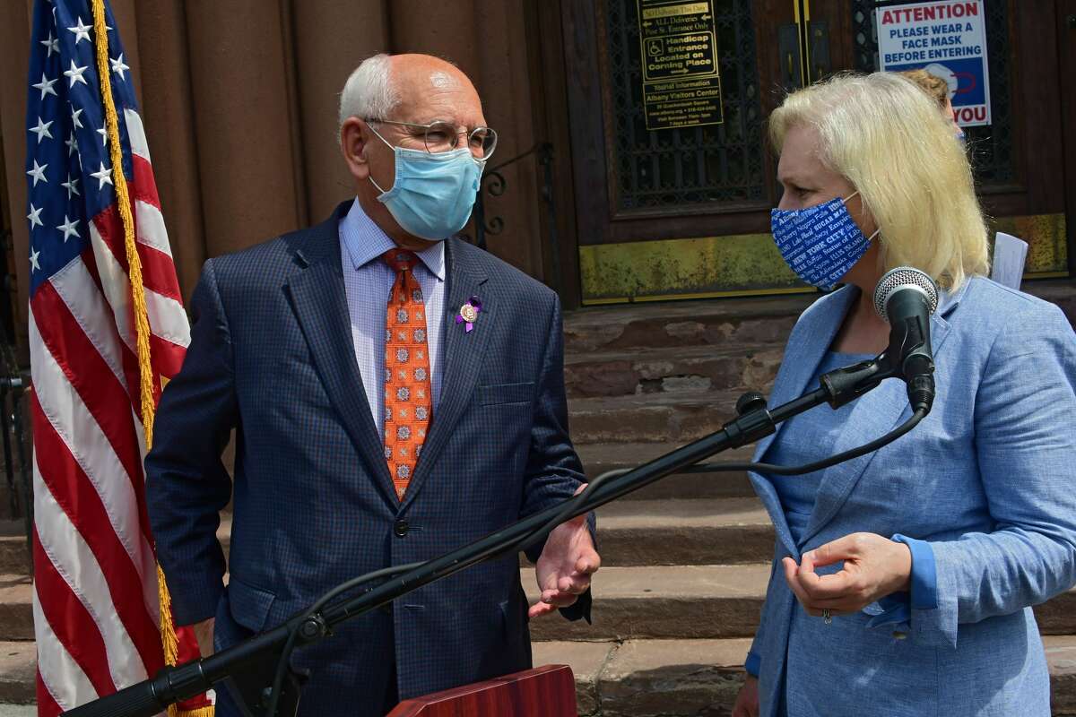 U.S. Representative Paul Tonko speaks with U.S. Senator Kirsten Gillibrand after they stood at Albany City Hall to call for legislation to provide local governments with direct federal relief that can be used to pay for essential services, offset lost revenues and increased costs from the COVID-19 emergency on Thursday, Aug. 6, 2020 in Albany, N.Y. (Lori Van Buren/Times Union)