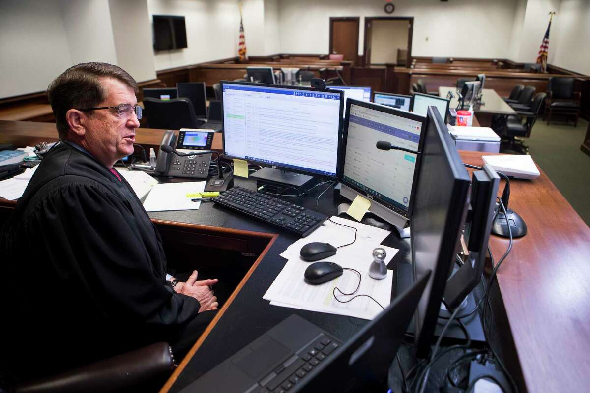 Chief United States Bankruptcy Judge David R. Jones hears closing arguments via a computer connection in his empty courtroom at the Bob Casey Federal Courthouse on Monday, Aug. 31, 2020 in Houston. Judge Jones has built the local court into one of the busiest in the nation, one that handles a number of complex bankruptcies.