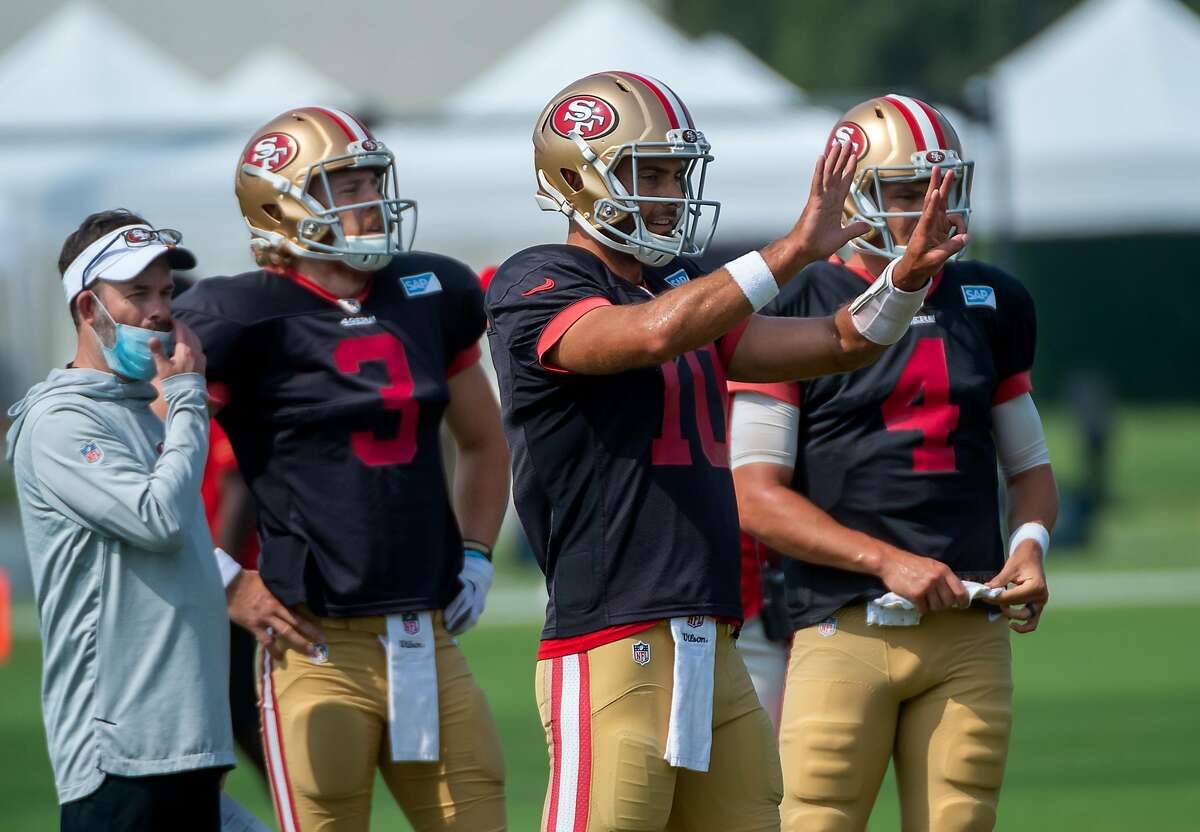 San Francisco 49ers quarterback Jimmy Garoppolo (10) gives directions with fellow QBs C.J. Beathard (3) and Nick Mullens (4) during training camp at Levi's Stadium on Tuesday, Aug 25, 2020 in Santa Clara.