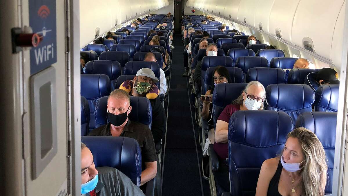 Masked passengers fill a Southwest Airlines flight from Burbank, Calif., to Las Vegas on June 3, 2020, with middle seats left open. 